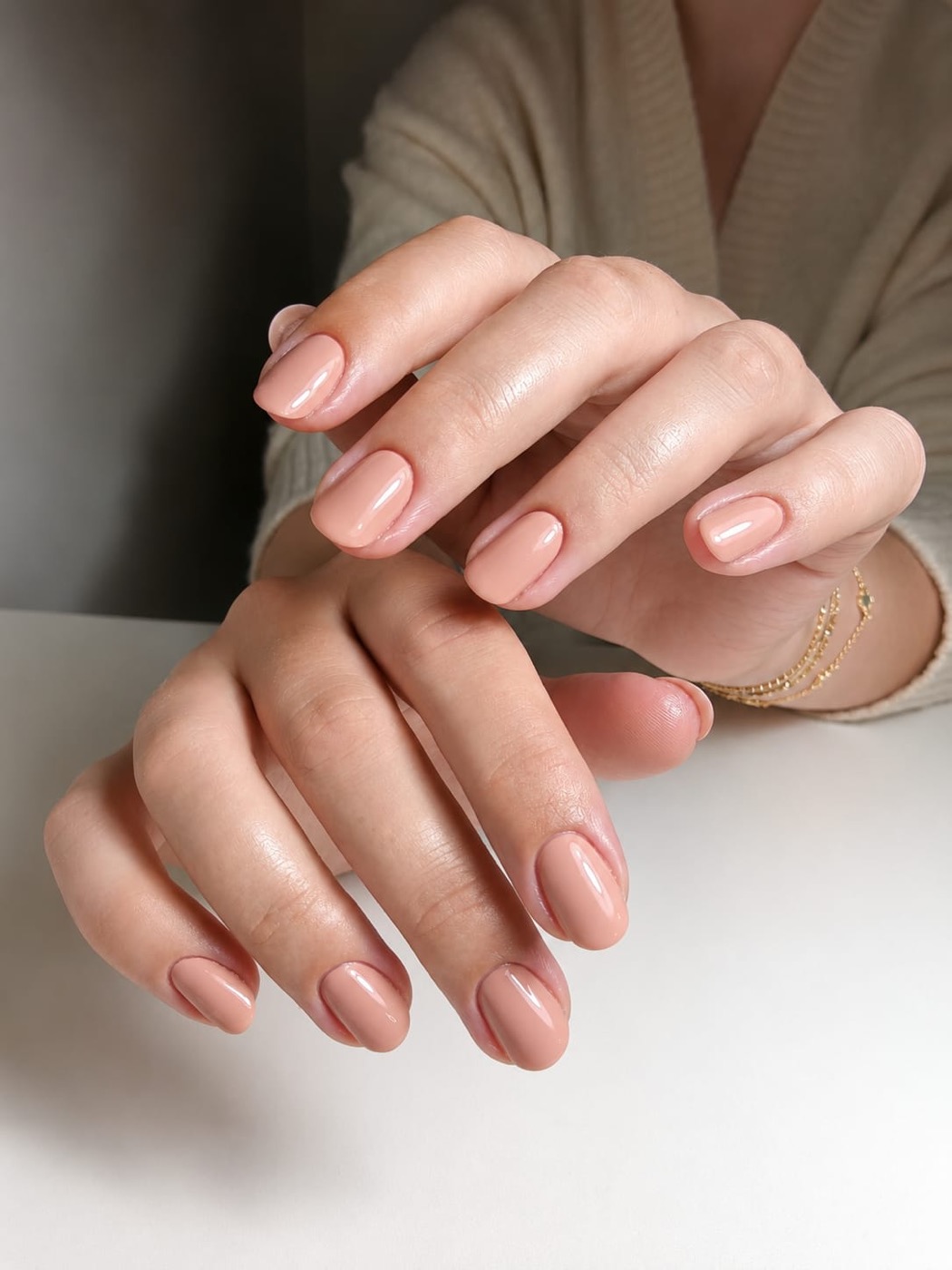 Hands with rounded nude-pink biab gel nails